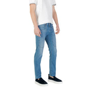 Man wearing light blue jeans and black slip-on shoes for men’s fashion product display