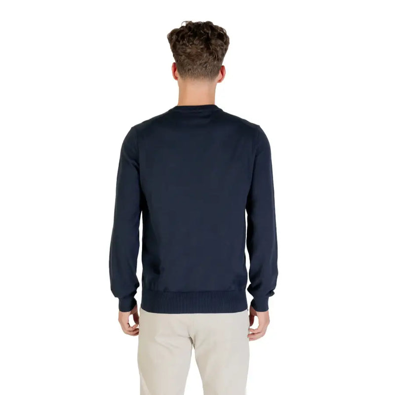 Man wearing navy blue sweater and khaki pants showcasing the Man in Navy Blue Sweater and Khaki Pants product