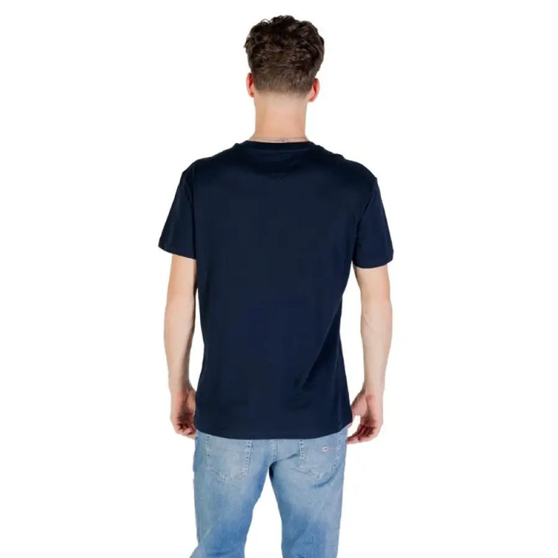 Man wearing Tommy Hilfiger navy blue T shirt and jeans