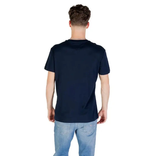 Man wearing Tommy Hilfiger navy blue T shirt and jeans