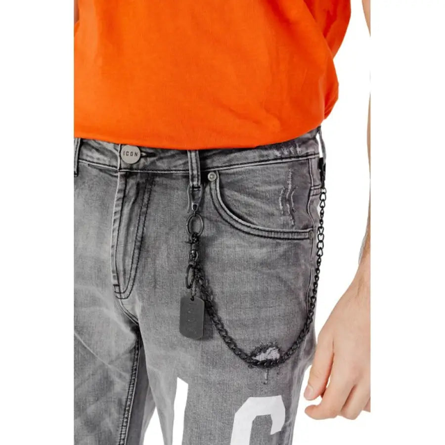 
                      
                        Man in orange shirt showcasing Icon Men Jeans for urban city style clothing
                      
                    
