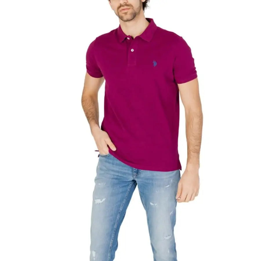 
                      
                        Man in U.S. Polo Assn. pink polo shirt and jeans, showcasing men’s polo apparel accessories.
                      
                    