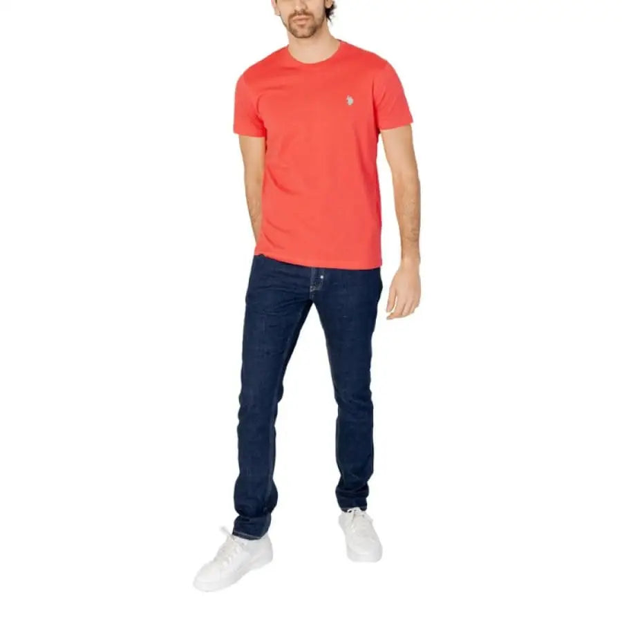 
                      
                        Man in U.S. Polo Assn. red t-shirt and jeans, men apparel accessories.
                      
                    