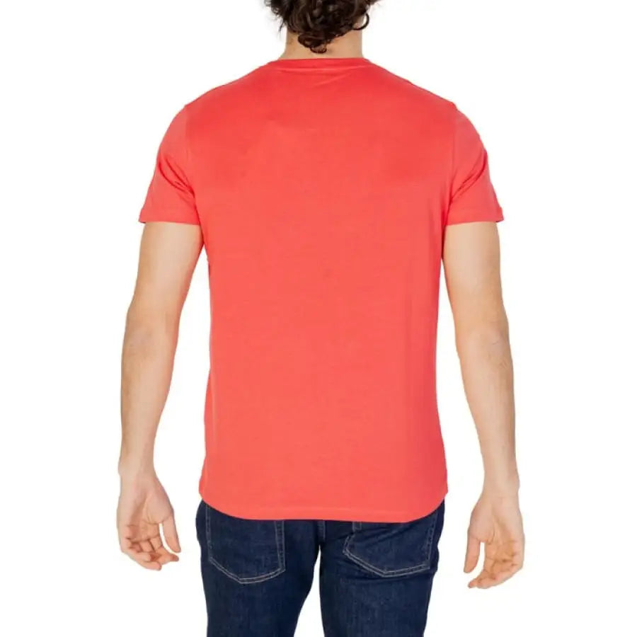 
                      
                        Man in red U.S. Polo Assn. men t-shirt and jeans - apparel accessories.
                      
                    