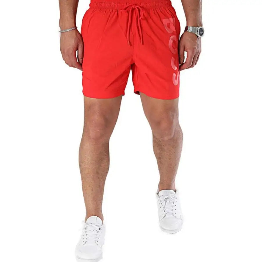 
                      
                        Boss boss men swimwear model in red shorts and white sneakers
                      
                    