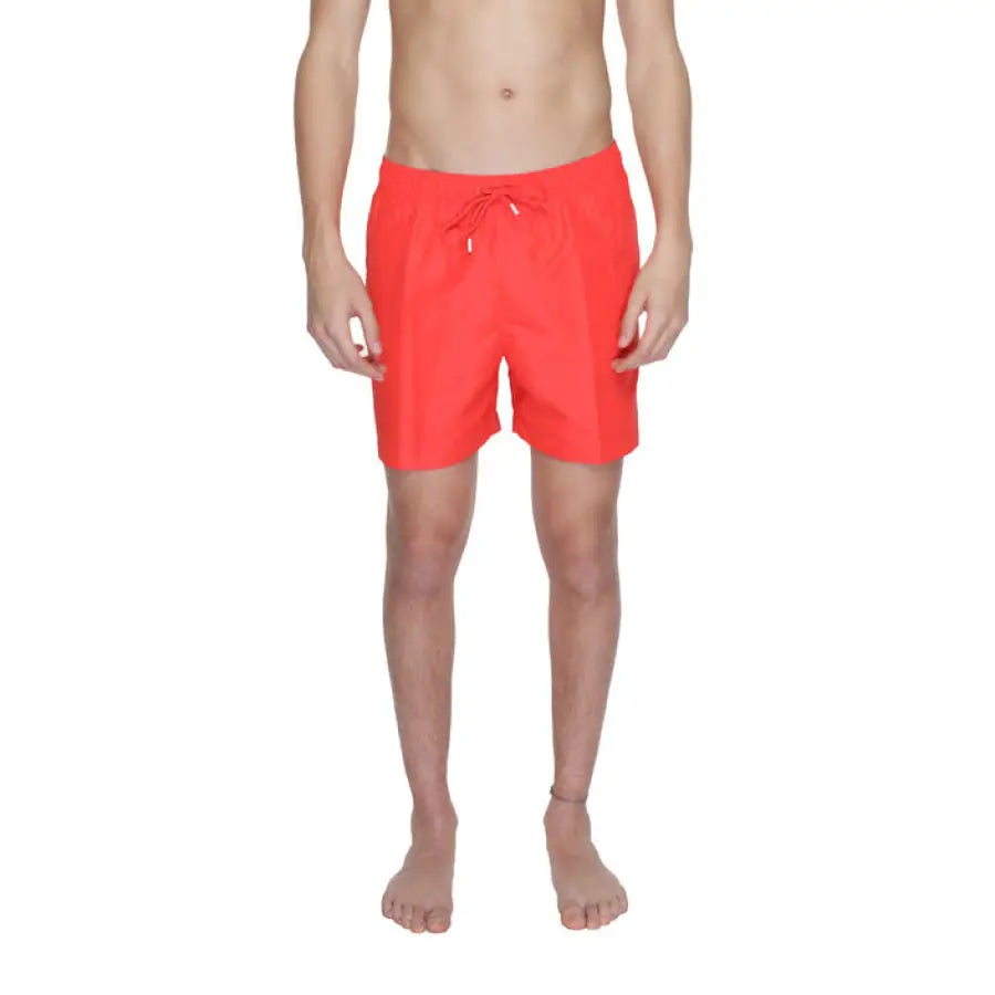 
                      
                        Man modeling Calvin Klein red swim trunks for Calvin Klein Men Swimwear collection
                      
                    
