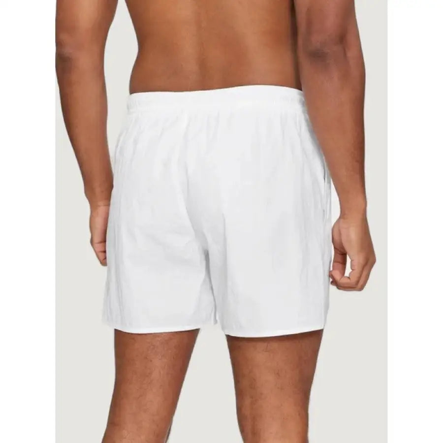 
                      
                        Emporio Armani underwear for men, model in white boxers shorts
                      
                    