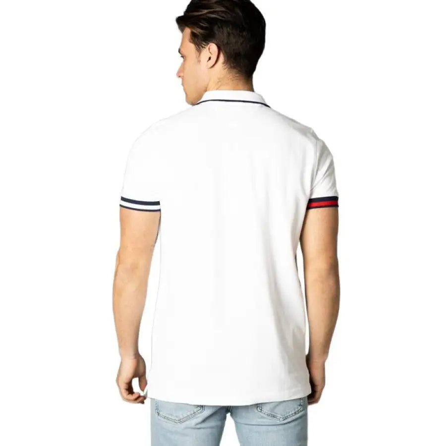 Man in Tommy Hilfiger Jeans polo with red and blue stripe