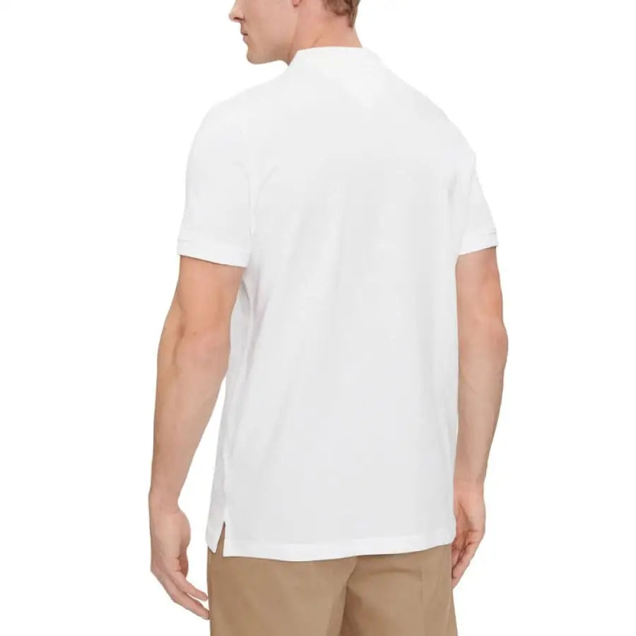 Man in white Tommy Hilfiger polo shirt from Tommy Hilfiger Jeans collection