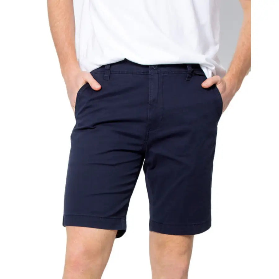 Man in white shirt and Levi’s shorts showcasing urban city style fashion