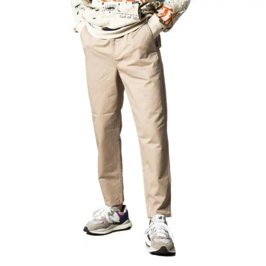 Model wearing Only & Sons men trousers in white shirt and khaki pants