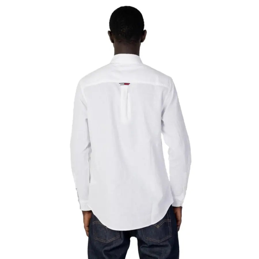 Man modeling Tommy Hilfiger jeans and white Tommy Hilfiger shirt