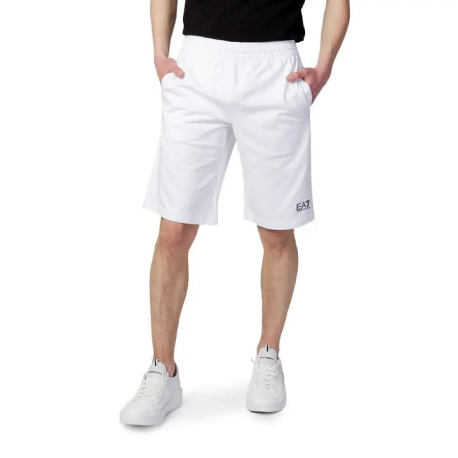 Ea7 men shorts for spring summer featuring a man in white shorts and a black t-shirt.