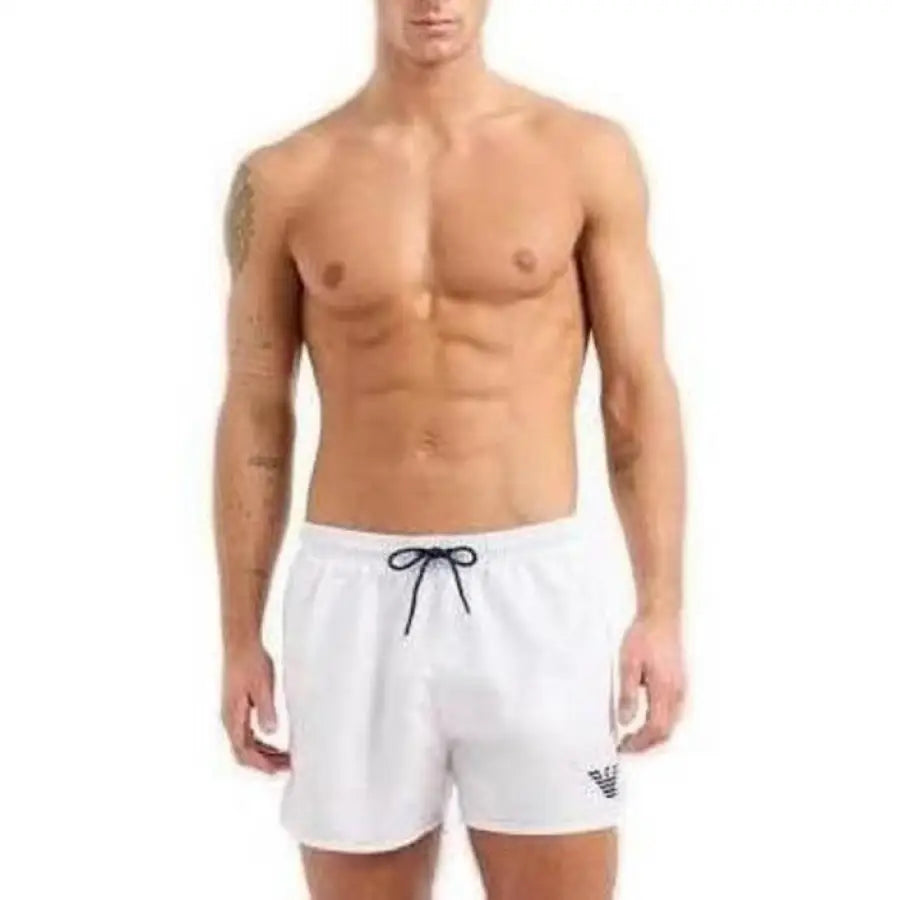 
                      
                        Emporio Armani Underwear model in white shorts and black shirt - men swimwear
                      
                    