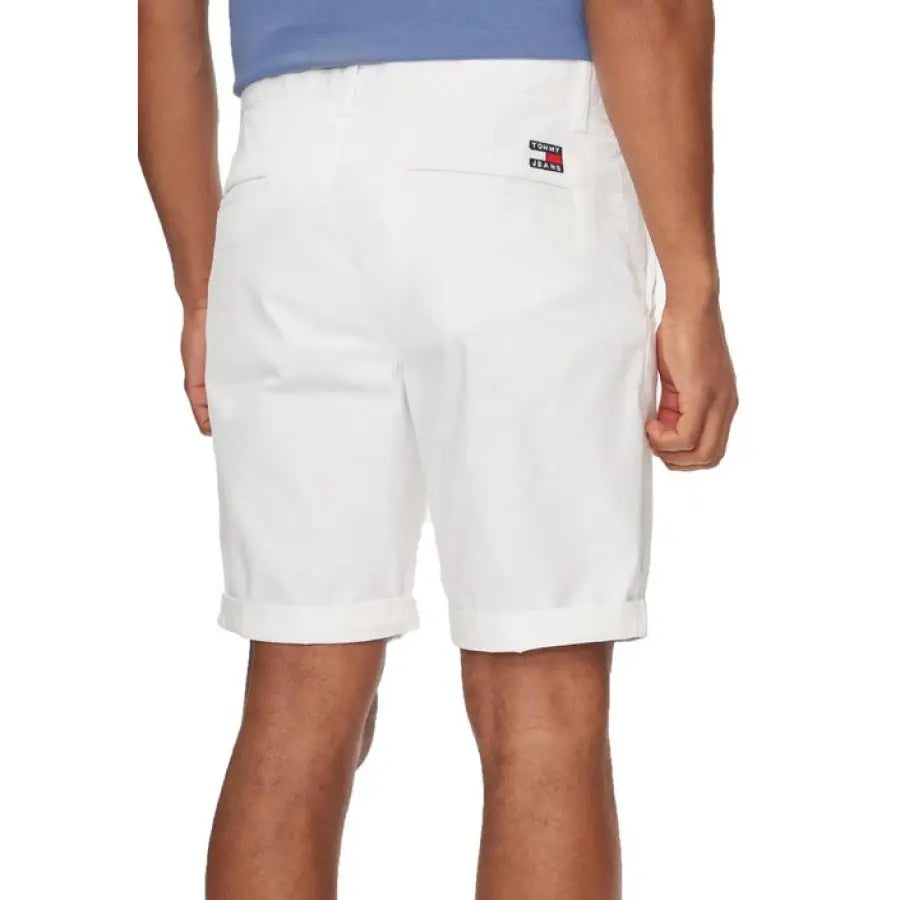 
                      
                        Man in Tommy Hilfiger Jeans blue shirt and white shorts
                      
                    