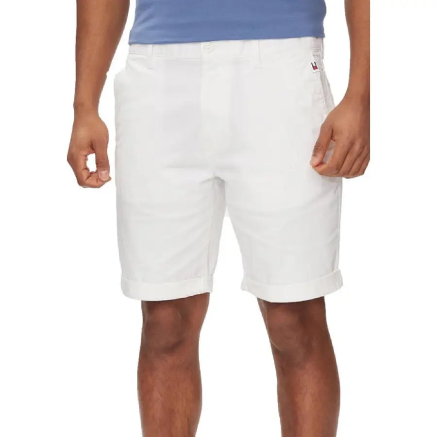 Man in Tommy Hilfiger jeans white shorts and blue shirt
