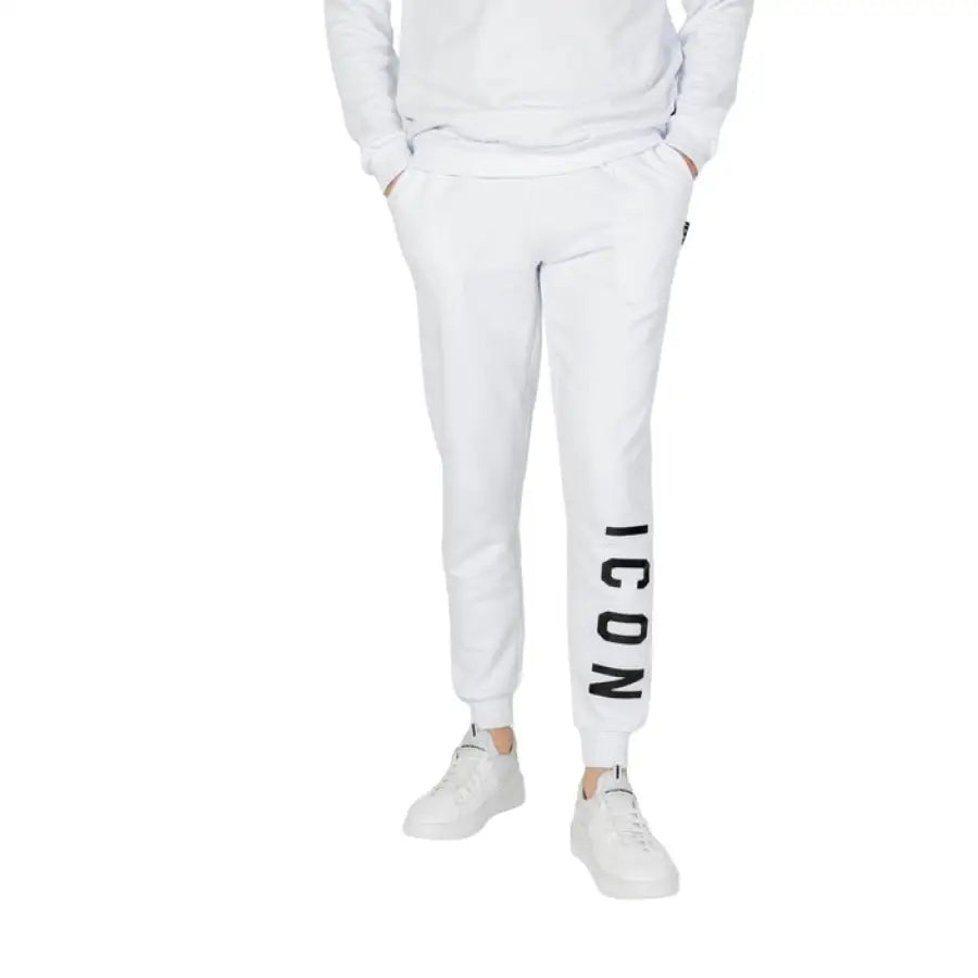 
                      
                        Icon Icon Men posing in Icon Men Trousers, white sweatshirt and pants outfit
                      
                    