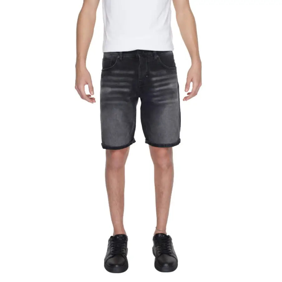 Man wearing Antony Morato men shorts for urban style clothing in city setting