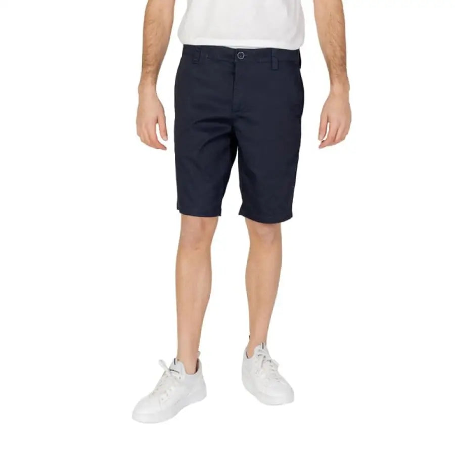 Armani Exchange Men Shorts for spring summer, featuring man in white t-shirt and black shorts.