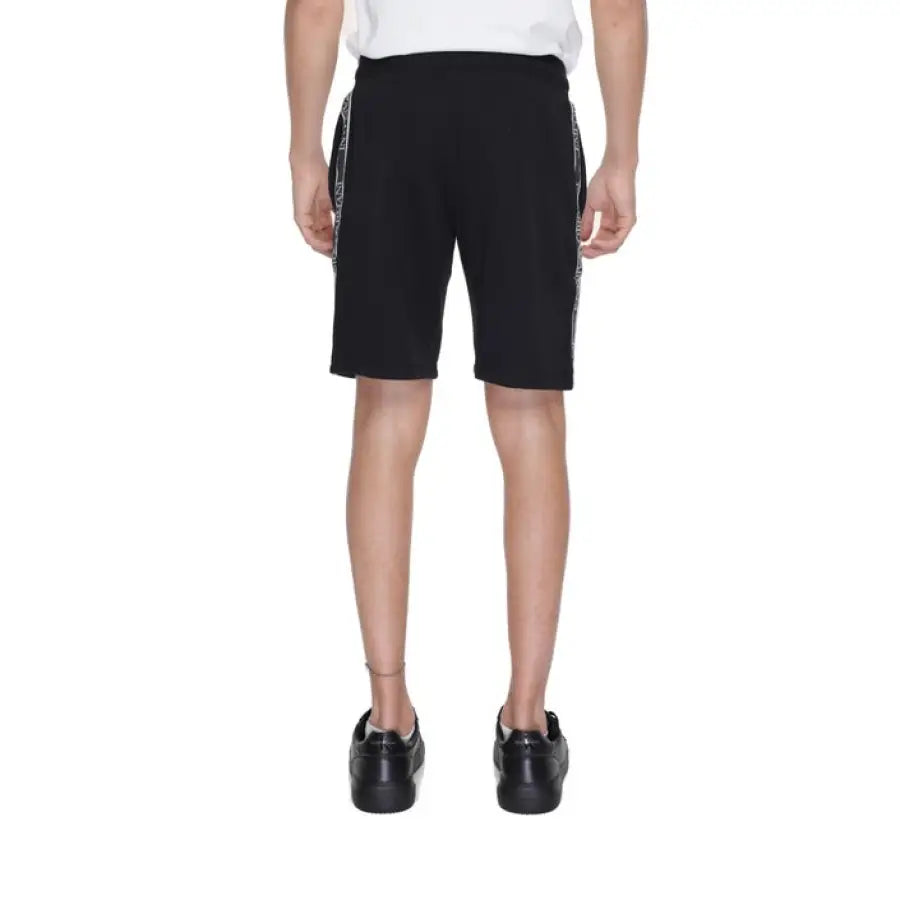 
                      
                        Man in Emporio Armani underwear, white T-shirt and black shorts
                      
                    