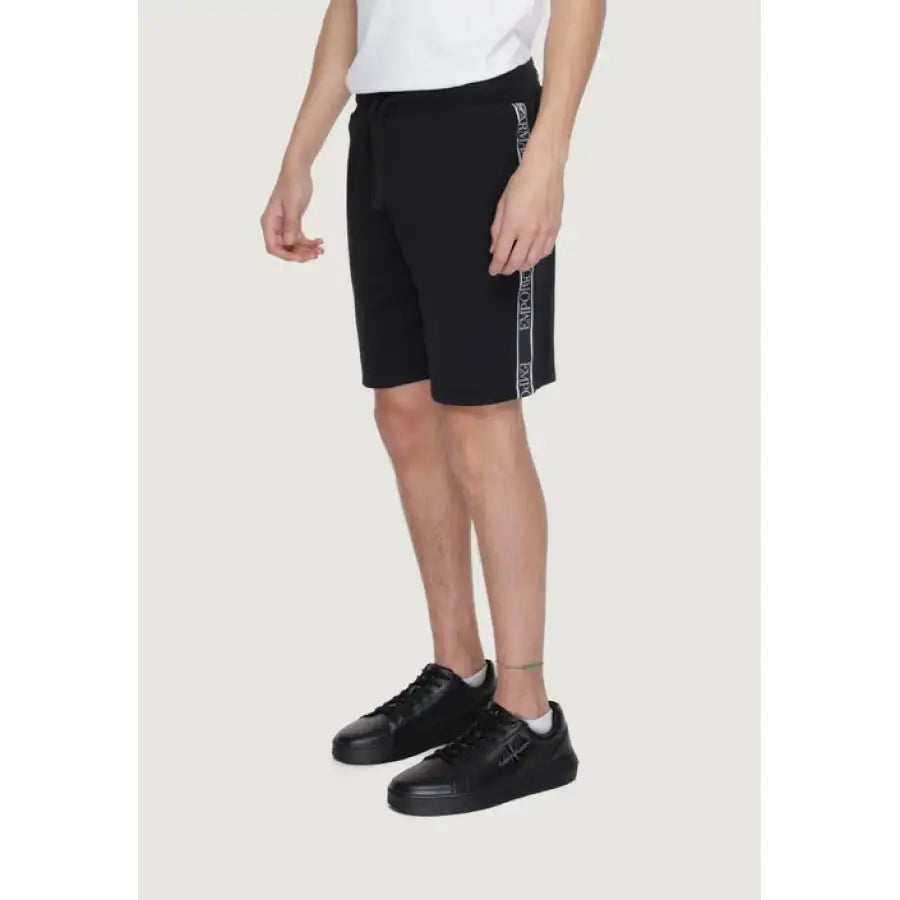 
                      
                        Emporio Armani Underwear model in white tee and black shorts
                      
                    
