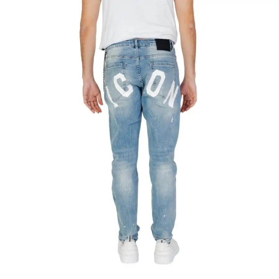 
                      
                        Man in Icon Men Jeans with heart design showcasing urban city style clothing
                      
                    