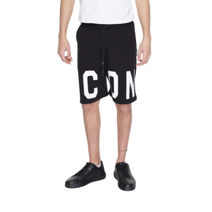 
                      
                        Man in Icon urban style clothing: white t shirt, black Icon Men Shorts
                      
                    