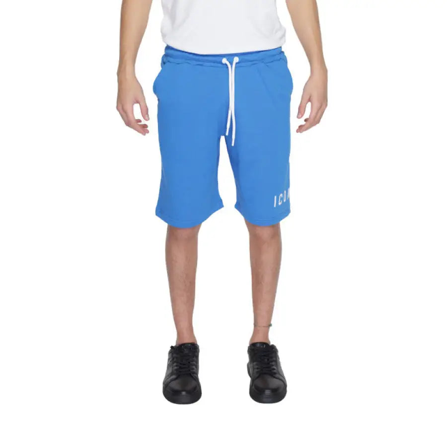 
                      
                        Man in white t-shirt and blue Icon-Icon shorts showcasing urban city style clothing
                      
                    
