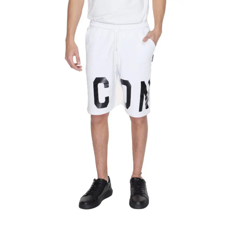 
                      
                        Man in white T-shirt and Icon Men Shorts showcasing urban city style fashion
                      
                    
