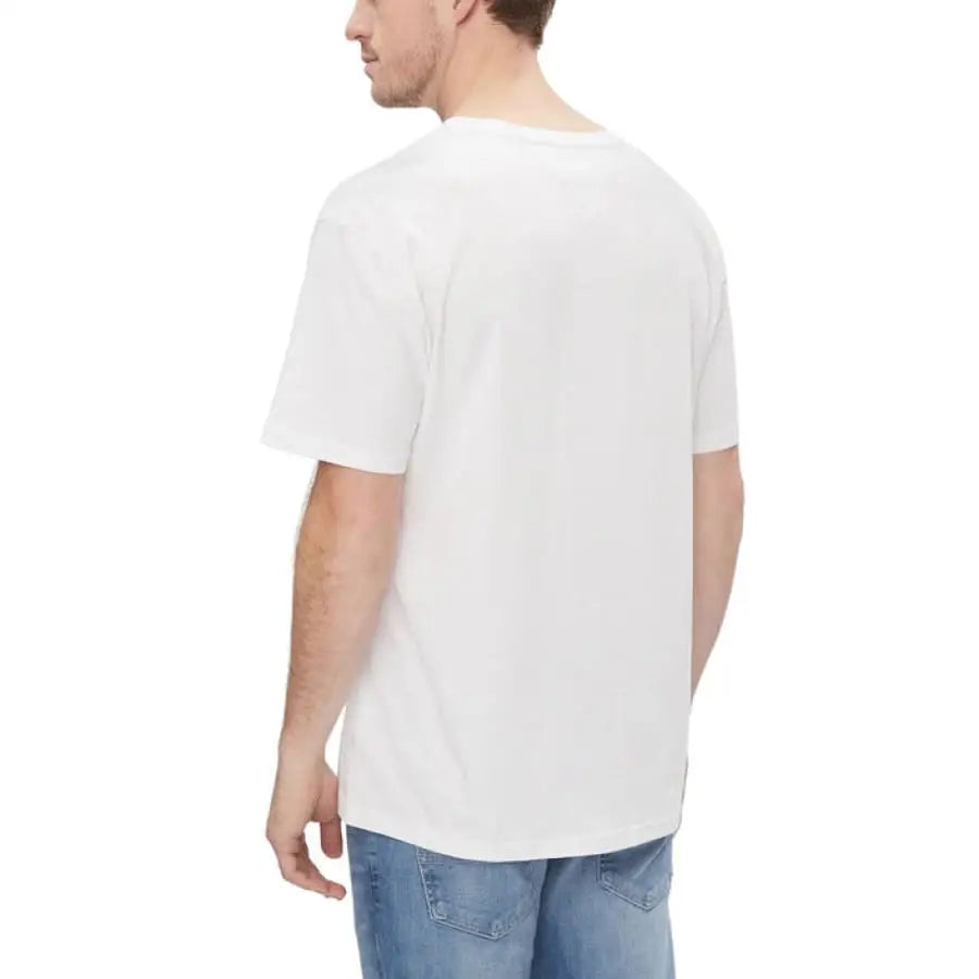 Man modeling Tommy Hilfiger Jeans and white T-shirt.
