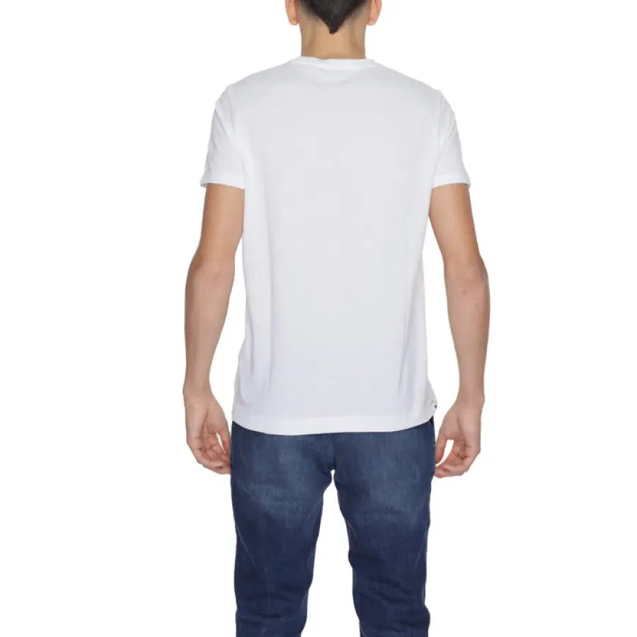 
                      
                        Man in white U.S. Polo Assn. men t-shirt and jeans showcasing urban style clothing
                      
                    