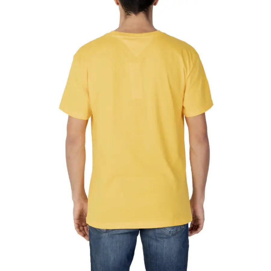 Man smiling in Tommy Hilfiger Jeans yellow t-shirt