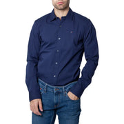 Men’s navy blue long-sleeved button-up shirt from Tommy Hilfiger displayed in product image