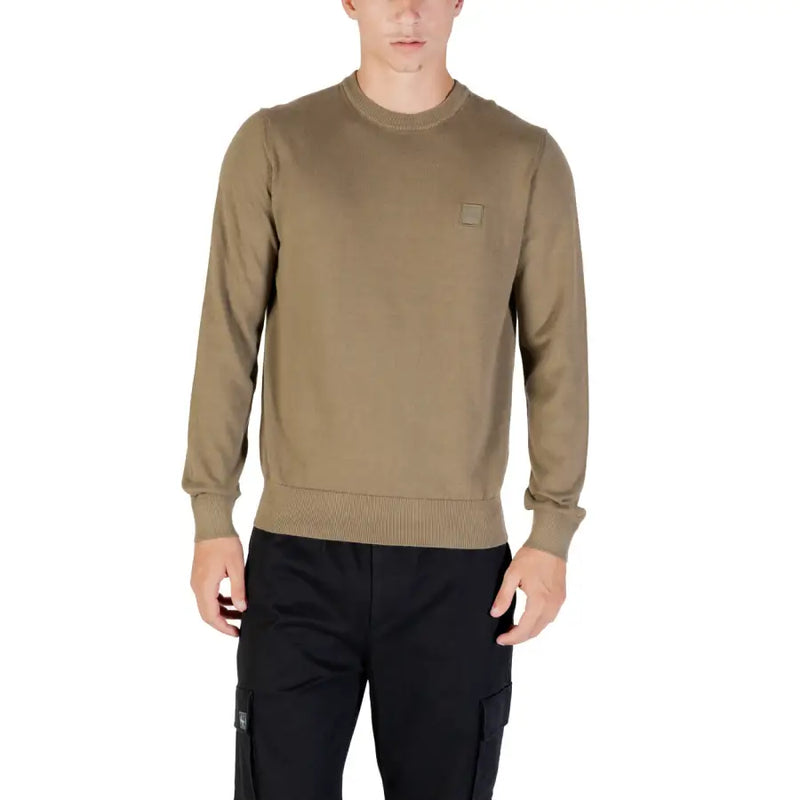 Olive green crew neck sweatshirt with a small face logo on the chest.