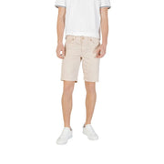 Man wearing beige shorts and white sneakers from Mens Casual Shorts T Shirt And Sneaker Collection