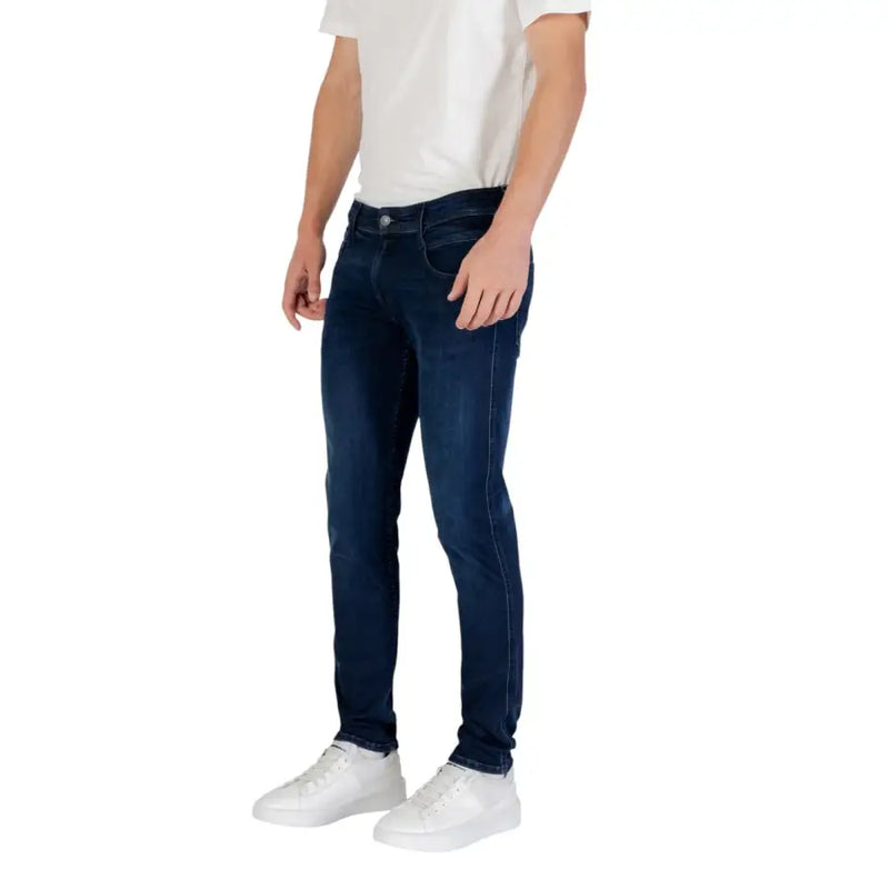 Mens dark blue slim fit denim jeans with classic five-pocket design and subtle fading for a modern worn-in look