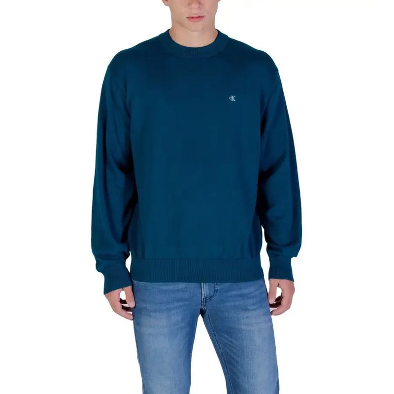 Dark teal crewneck sweatshirt with calvin klein logo on left chest.