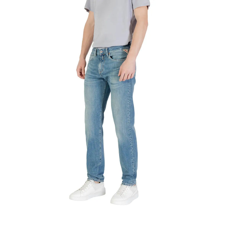 Men’s light blue denim jeans with a slim fit, subtle fading, classic stitching, and branded patch on the back pocket view