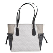 Michael Kors black slip on handbag tote with light gray and black two tone panels and signature monogram pattern