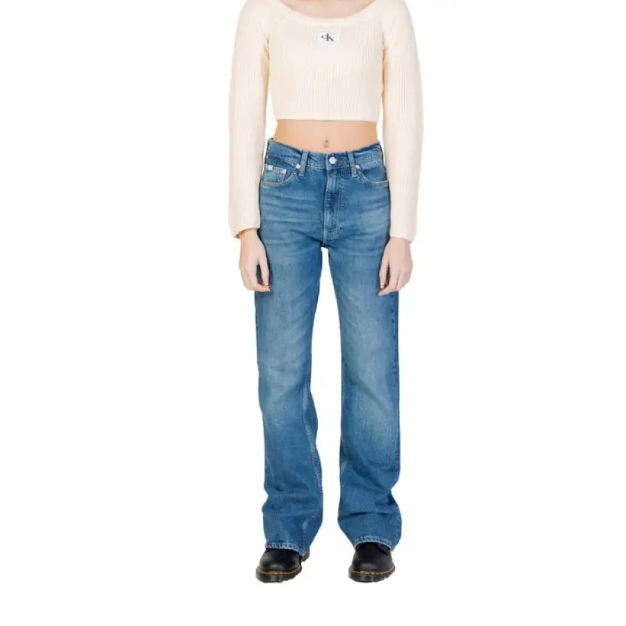 Model in Calvin Klein jeans and white crop top showcasing Calvin Klein Women Jeans