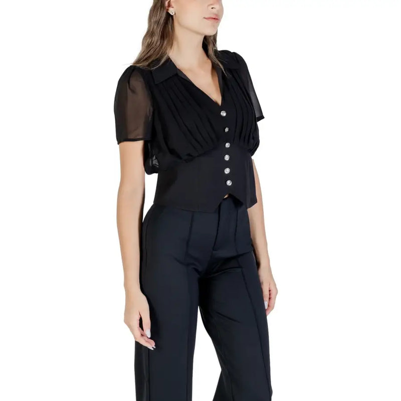 Black V neck blouse with shiny buttons paired with black trousers for Fall Winter fashion