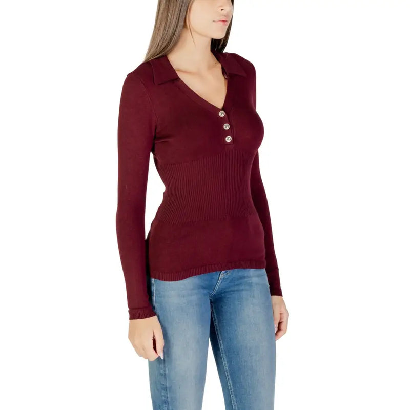Woman modeling Bordeaux long V-neck button front knit sweater with blue jeans