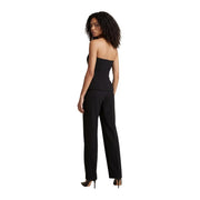 Schwarzer, trägerloser, figurbetonter Jumpsuit mit passender Hose, kombiniert mit High Heels von Morgan De Toi Baumwollkollektion