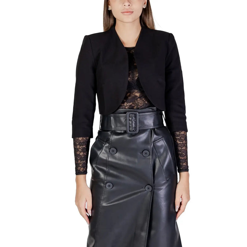 Morgan De Toi women’s black cardigan with 3/4 sleeves featuring lace-trimmed cuffs paired with black faux leather skirt and belt