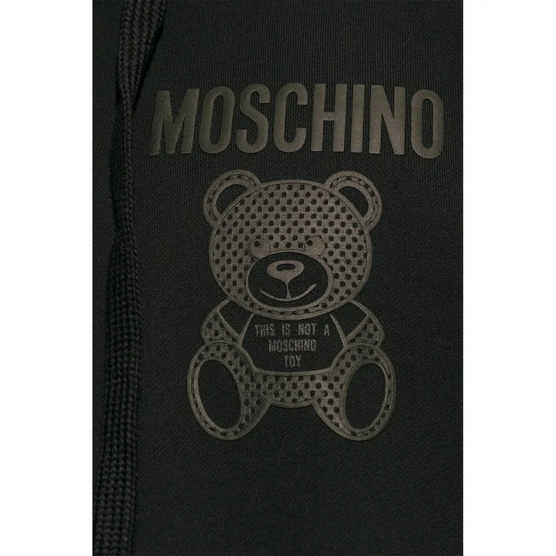 Black cotton Moschino men sweatshirt hoodie featuring perforated teddy bear graphic with brand slogan on front