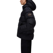 Black puffer jacket with hood and brand patch on sleeve.