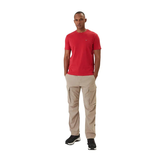 Beige cargo pants with multiple side pockets and subtle napapijri logo on left thigh paired with red cotton t shirt