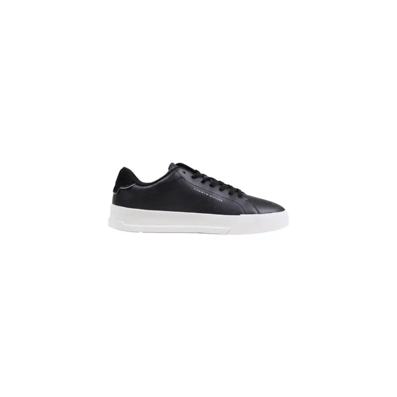 Black leather low-top sneaker with white sole and laces, classic design.