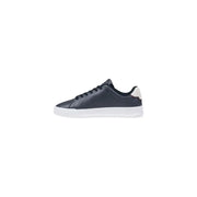Dark navy leather low-top sneaker with white rubber sole and cream-colored heel tab by Tommy Hilfiger