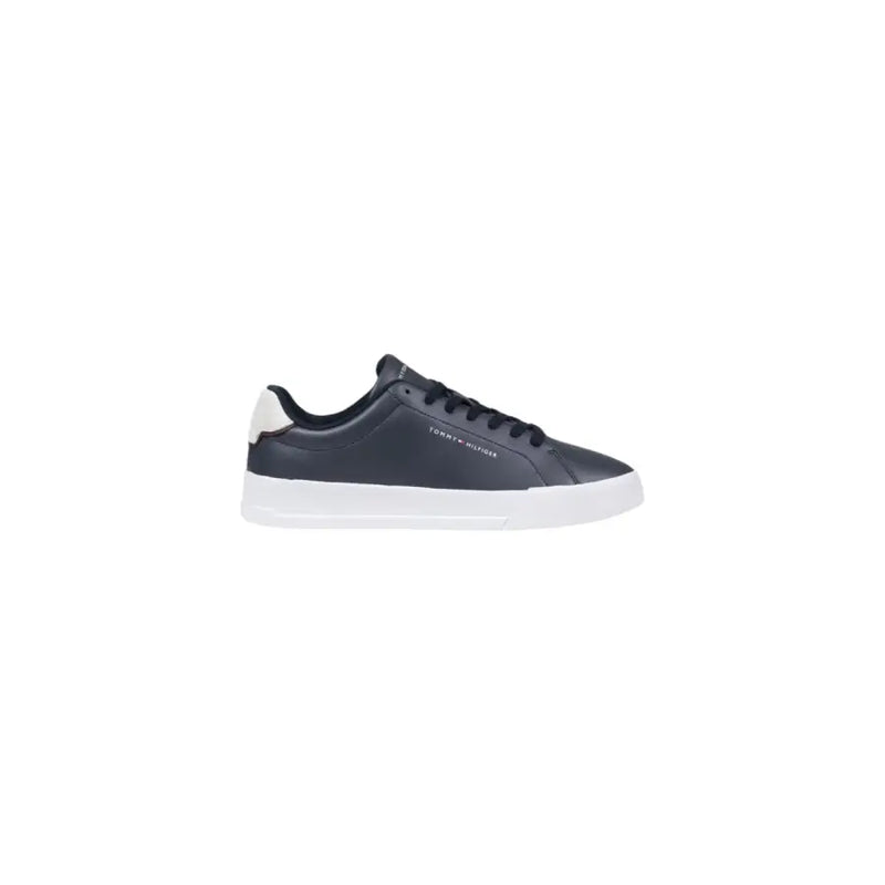 Dark navy leather Tommy Hilfiger low-top sneaker with white rubber sole and cream-colored heel tab visible from the back
